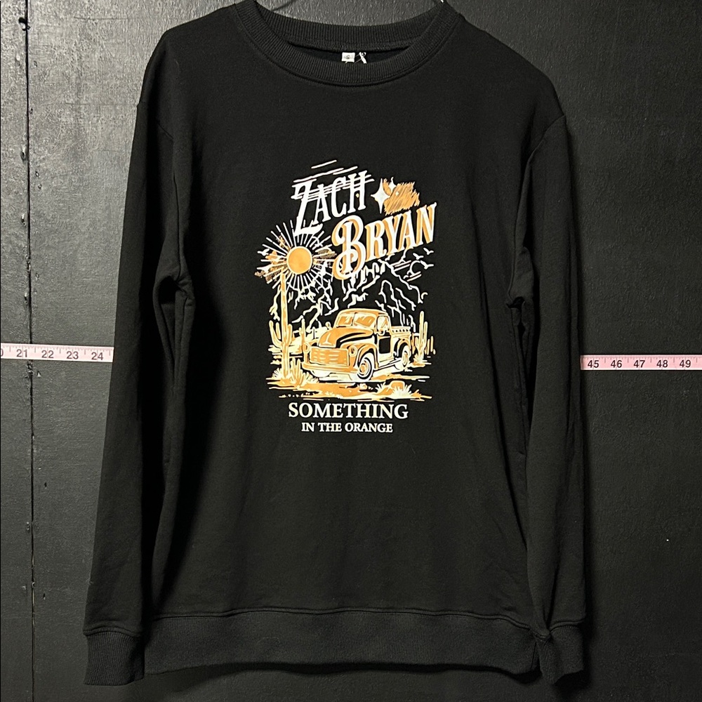 Zach Bryan something in orange crewneck